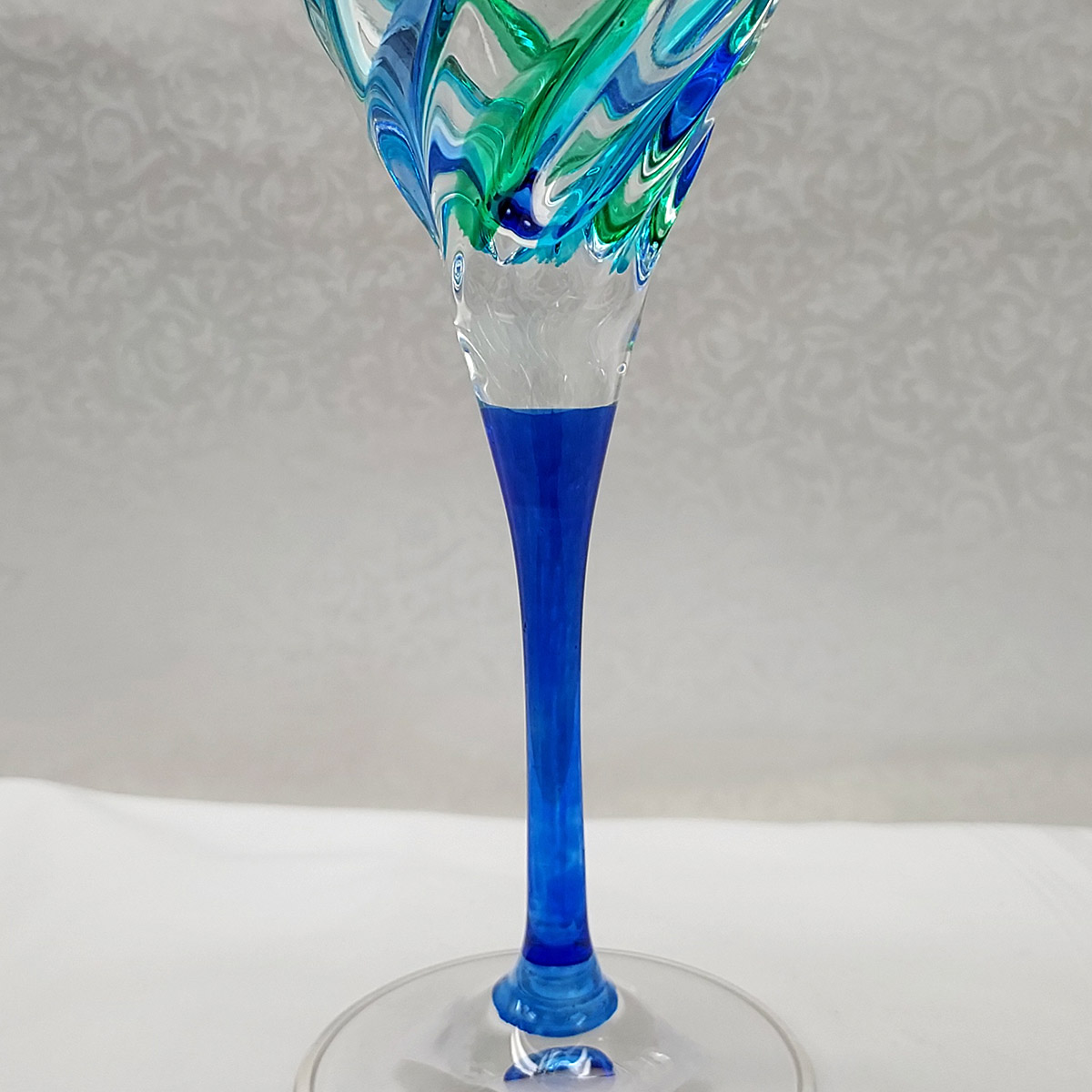 https://www.luxuriousinteriors.com/wp-content/uploads/2022/09/trix-peacock-wine-blue-stem.jpg